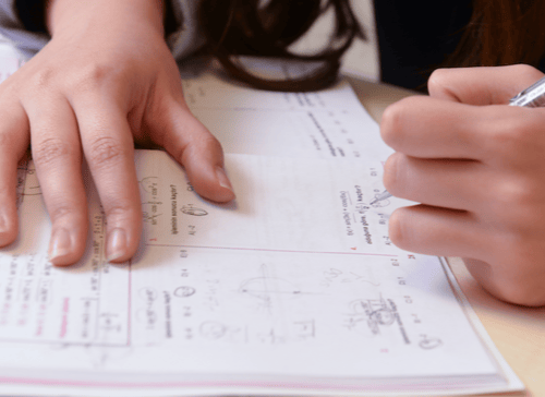 student solving math workbook